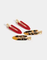 Set de cuatro hebillas para el pelo, dos de color rojo y dos con estampado carey.