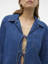 Camisa de denim azul con detalle de lazo frontal y corte holgado.