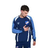 Buzo azul marino de algodón con recortes en blanco y celeste en mangas y hombros. Logo de Umbro bordado en blanco y escudo del Club Nacional de Football estampado en el pecho.