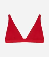 Soutien top deportivo color rojo, sin copa, con breteles finos y elásticos y banda inferior con inscripción de la marca Lov.