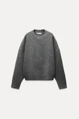 Sweater gris de punto suave con cuello redondo y manga larga.