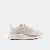 Championes New Balance 680 V8 color crema con logo plateado y detalles en rosa.