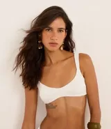 Top de bikini blanco con textura acanalada, corte tipo remera, breteles anchos fijos y copas removibles.