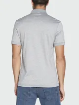 Remera polo gris de algodón, corte regular fit, con cuello clásico abotonado y logo cuadrado negro en el pecho. Modelo Parlay 143 de Boss.
