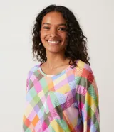 Pijama largo de poliéster con estampado de cuadros multicolores, puños ajustados de canalé, cuello redondo y bolsillo en el pecho.