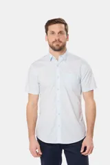 Camisa de hombre color azul marino, de manga corta, con cuello clásico, cierre frontal con botones y bolsillo en el pecho.