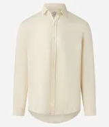 Camisa blanca de manga larga, corte amplio y cuello padre (mandarín). Presenta un frente abotonado con tapeta corta.