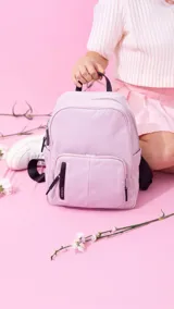 Mochila negra de nylon con cierre principal y dos bolsillos frontales con cierre.