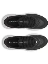 Zapatillas de running Under Armour modelo Turbulence 3 para mujer, color negro con suela blanca gruesa. Presentan un upper de malla transpirable y el logo de Under Armour en el talón.