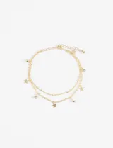 Tobillera dorada de doble cadena con dije de estrella y strass.