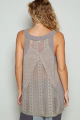 Top sin mangas color beige con escote en V y cordones cruzados. Presenta detalles de encaje en los laterales y en el ruedo.