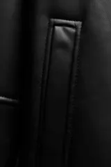 Cazadora de cuero sintético negro con interior de borreguillo color crema. Tiene cuello solapa, mangas largas, bolsillos delanteros y cierre con botones.