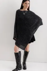 Poncho negro con detalles en gris, de tejido de punto grueso y corte asimétrico.