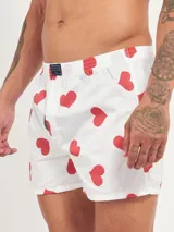 Bóxer de algodón con estampado floral en tonos azul y blanco, con cintura elástica y logo de la marca en el centro.