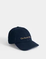 Gorra de denim azul con bordado en color dorado con la frase "The Brunch Club".