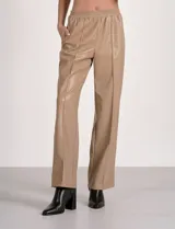 Pantalón de eco cuero color marrón, marca Elan, con pretina elastizada, bolsillos delanteros, pierna recta y costura frontal.