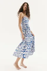 Vestido midi con estampado floral azul y blanco, breteles finos ajustables, escote cuadrado y cuerpo en punto smock.