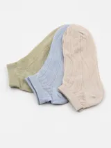 Pack de tres pares de medias de punto calado en colores beige, celeste y verde claro.