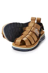 Sandalias con tiras de tela color beige, suela gruesa con detalles geométricos y ajuste con velcro.