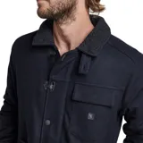 Campera de paño azul oscuro con cuello de corderito, cierre con botones a presión y múltiples bolsillos.