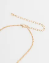 Cadena corta dorada con dije de la letra A cubierto de strass.