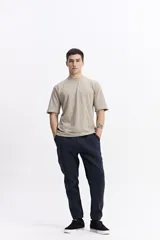 Remera lisa color beige de corte oversize, con escote redondo y mangas cortas.