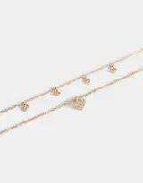 Collar corto dorado multicadena con dije de moño y mini dijes con strass.