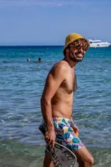 Short de baño para hombre con estampado de hojas de palmera y peces. Tiene elástico en la cintura, tres bolsillos y tela de secado rápido.