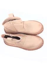 Botín color beige de cuero con suela marrón de goma.