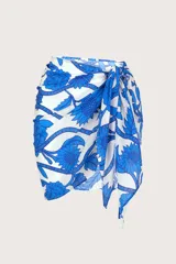 Pareo corto de playa con estampado floral en tonos azules y blancos.