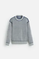 Jersey de punto con cuello redondo y manga larga. Diseño a rayas verticales en color azul marino y blanco.