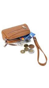 Monedero negro de simil cuero con correa para la mano, diseño práctico y compacto. Bolsillo principal con doble cierre, y un bolsillo frontal pequeño para llevar monedas.
