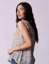 Blusa sin mangas de gasa estampada, marca Zac & Rachel. Escote en V, abertura central con botones y ruedo con volado.