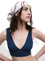 Pañuelo de seda con estampado que evoca ondas del mar, en tonos blanco y marrón.