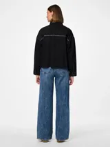 Camisa de denim negra con mangas largas, calce regular, bolsillos frontales y detalles de cristales en los hombros.