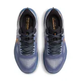 Championes de running Nike Vomero 17, color azul con detalles en naranja y negro.