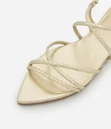 Sandalia plana dorada con punta de hoja y tiras finas con textura de serpiente. Ajuste con hebilla en el tobillo.