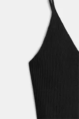 Top negro de punto con escote en pico y tirantes finos.