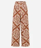 Pantalón pantalona con cintura alta, cintura ancha con botones forrados en los laterales y estampa tropical estilo pañuelo con flores.