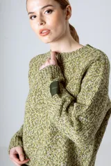 Sweater tejido de punto grueso color rojo y blanco con cuello redondo y puños acanalados.