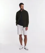 Camisa blanca de manga larga, confeccionada en terciopelo con cuello clásico y bolsillos frontales.