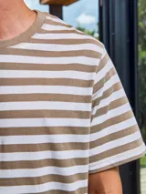 Camiseta de manga corta a rayas horizontales color marrón y blanco, con cuello redondo y corte relajado.