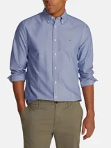Camisa de vestir celeste con microestampado, de corte regular, cuello abotonado y manga larga. Incluye logo de Tommy Hilfiger bordado en el pecho.