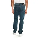 Pantalón de jean color verde militar, de corte slim, con cinco bolsillos y logo CAT en la parte trasera.