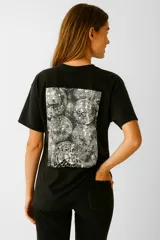 Remera negra de algodón con estampa frontal con la frase "More Glitter" en color rosa.