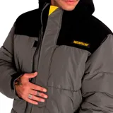 Campera puffer amarilla con cuello alto y parte superior en pana negra. Tiene cierre frontal con velcro, bolsillos laterales con cierre y puños ajustables.