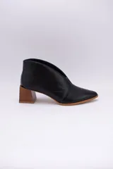 Botines color peltre de cuero con taco de madera y corte en V en el frente.