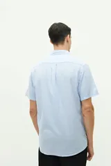 Camisa de manga corta color beige claro, confeccionada en lino y algodón, con fit regular y logo bordado en el pecho.