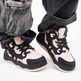 Zapatillas de skate de caña alta color rosa pálido y detalles en negro.