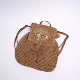 Mochila de yute color marrón con aplique de ojo bordado con lentejuelas y flecos.
